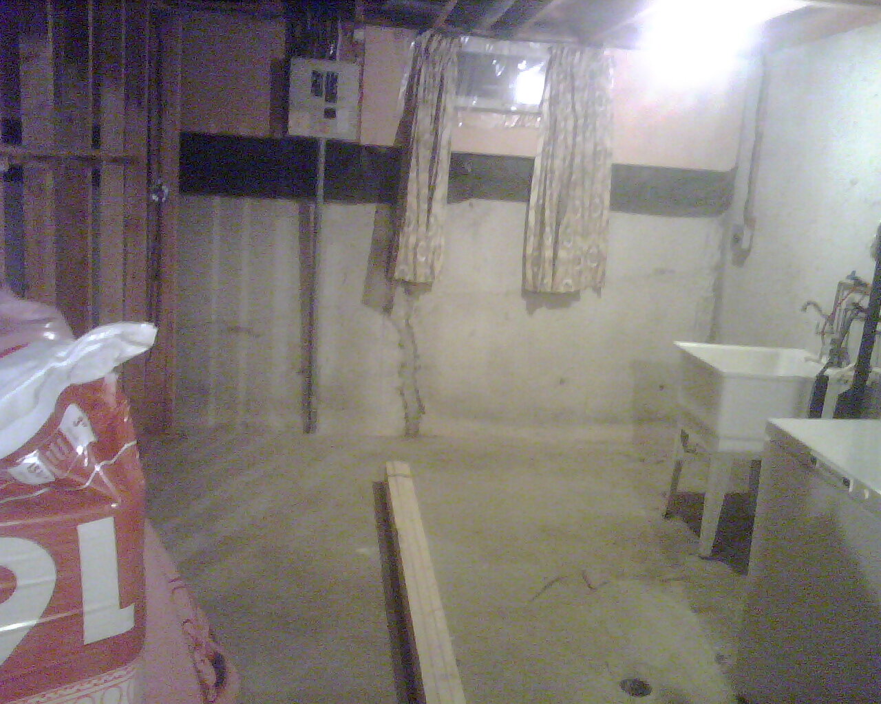 Basement's washer and dryer area with all the gas and electric stuff (this area will be tiled lamenated when the basement room is built)