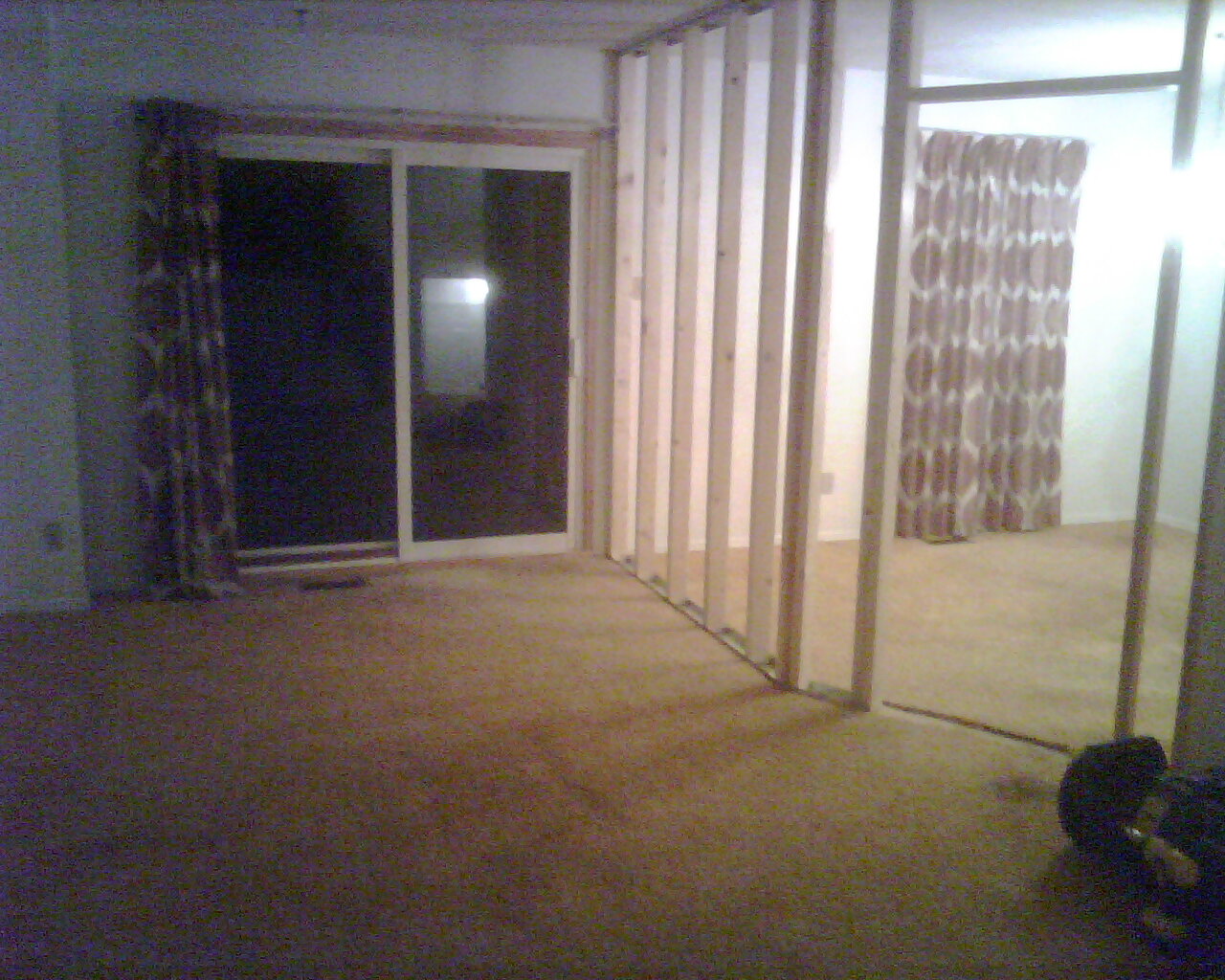 The living room's back end as seen from near the entrance stairs (the beams are for the room being constructed on the first floor)